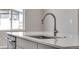 Modern kitchen featuring sleek countertops and a stainless steel faucet and a stainless dishwasher at 6863 Oak Canyon Cir, Castle Pines, CO 80108