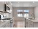 Modern kitchen with stainless steel appliances, island, and light hardwood floors at 6863 Oak Canyon Cir, Castle Pines, CO 80108