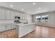 Bright, modern kitchen with stainless steel appliances, island and light wood floors at 6863 Oak Canyon Cir, Castle Pines, CO 80108
