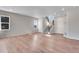 Bright, open-concept living room with sleek hardwood floors, a staircase, and natural light from nearby windows at 6863 Oak Canyon Cir, Castle Pines, CO 80108