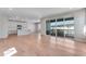 Bright, open-concept living room seamlessly connects to the modern kitchen, featuring sleek hardwood floors at 6863 Oak Canyon Cir, Castle Pines, CO 80108