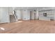 Bright, open-concept living room seamlessly connects to the modern kitchen, featuring sleek hardwood floors and stairs at 6863 Oak Canyon Cir, Castle Pines, CO 80108