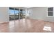 Bright, open-concept living room with sleek hardwood floors and a large sliding glass door to the deck at 6863 Oak Canyon Cir, Castle Pines, CO 80108