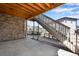 Outdoor patio with exposed wood beams and access to backyard and upper deck at 6863 Oak Canyon Cir, Castle Pines, CO 80108
