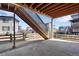 An outdoor covered patio with wooden beam ceiling and view of neighborhood at 6863 Oak Canyon Cir, Castle Pines, CO 80108