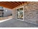 Covered outdoor patio with stone siding and views of the backyard at 6863 Oak Canyon Cir, Castle Pines, CO 80108