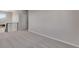 A large room with neutral carpet, modern railing, a window and white walls at 6863 Oak Canyon Cir, Castle Pines, CO 80108