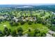 Aerial view of homes surrounding a golf course with mature trees and manicured lawns at 15 Latigo Pl, Littleton, CO 80123