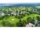 Aerial view of a golf course community with lush green fairways and a serene lake at 15 Latigo Pl, Littleton, CO 80123