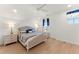Bedroom with hardwood floors, white walls, a ceiling fan, and bedside tables with lamps at 15 Latigo Pl, Littleton, CO 80123