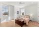 Cozy bedroom with a wrought iron bed frame, wood floors, and sheer curtains at 15 Latigo Pl, Littleton, CO 80123