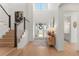 Bright entryway with high ceilings, hardwood floors, stairs, and decorative table with lamps at 15 Latigo Pl, Littleton, CO 80123