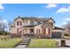 Charming two-story home with brick accents, red shutters, and well-manicured front yard at 15 Latigo Pl, Littleton, CO 80123