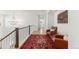 Upstairs hallway featuring a patterned rug, leather chairs, and decorative lighting at 15 Latigo Pl, Littleton, CO 80123