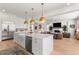 Open-concept kitchen with a large island, modern appliances, and seamless flow to the living room at 15 Latigo Pl, Littleton, CO 80123