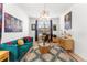 Eclectic living room featuring a blue velvet sofa, patterned rug, and unique decor at 15 Latigo Pl, Littleton, CO 80123