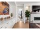 Elegant living space featuring a fireplace, built-in cabinets, and seamless access to other rooms at 15 Latigo Pl, Littleton, CO 80123