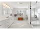 Luxurious main bathroom with double vanity, a freestanding tub, and glass shower at 15 Latigo Pl, Littleton, CO 80123