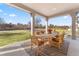 Covered patio features an outdoor dining area with views of the backyard and playground at 15 Latigo Pl, Littleton, CO 80123