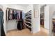 Organized walk-in closet with shelves and hanging rods, offering ample storage space for clothes and shoes at 15 Latigo Pl, Littleton, CO 80123
