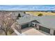 An aerial shot of a home with green shingles, a green garage door, and a golf course in the distance at 15123 Xenia St, Thornton, CO 80602