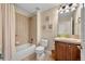 Cozy bathroom with tiled shower-tub, traditional vanity, and neutral tones at 15123 Xenia St, Thornton, CO 80602