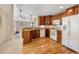 Well-appointed kitchen featuring hardwood floors, granite countertops, and modern appliances at 15123 Xenia St, Thornton, CO 80602