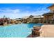 Resort-style pool area with elegant stone accents and clear blue water against a clubhouse backdrop at 15123 Xenia St, Thornton, CO 80602