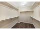 Spacious walk-in closet with built-in shelving and neutral carpeting for organized storage at 15123 Xenia St, Thornton, CO 80602