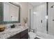 Modern bathroom with granite vanity, walk-in shower, and stylish mirror at 2730 Fox View Trl, Franktown, CO 80116