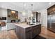 Modern kitchen with large island and stainless steel appliances at 2730 Fox View Trl, Franktown, CO 80116