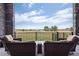 Relaxing patio furniture overlooks a beautiful grassy landscape at 2730 Fox View Trl, Franktown, CO 80116