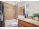 Stylish bathroom featuring tiled shower-tub combo, granite countertop sink, and neutral color scheme offers a relaxing space at 3426 N Gilpin St, Denver, CO 80205