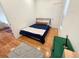 Cozy bedroom featuring hardwood floors, stylish rug, and minimalist decor at 3426 N Gilpin St, Denver, CO 80205