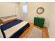 Comfortable bedroom with hardwood floors, neutral decor, and ample natural light at 3426 N Gilpin St, Denver, CO 80205