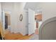Bright hallway with hardwood floors leading to bathroom and kitchen showcases the home's thoughtful layout and design at 3426 N Gilpin St, Denver, CO 80205
