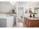 Bright laundry room with washer/dryer and granite vanity has easy access to the bedroom and a secondary bath at 3426 N Gilpin St, Denver, CO 80205