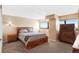 Main bedroom with large windows, city views, and wood furniture at 100 Park W Ave # 1804, Denver, CO 80205