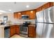 Kitchen featuring stainless steel appliances and warm wood cabinetry at 100 Park W Ave # 1804, Denver, CO 80205