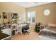 Comfortable bedroom with a large window and a study desk; complete with shelves for books and plants at 11023 Glengate Cir, Highlands Ranch, CO 80130