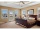 Main bedroom features tray ceiling, ceiling fan, private balcony and large windows at 11023 Glengate Cir, Highlands Ranch, CO 80130