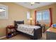 Well-lit bedroom features two windows, a twin bed, a desk, and bright curtains at 11023 Glengate Cir, Highlands Ranch, CO 80130