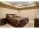 Bedroom featuring a bed with side tables, warm lighting, and neutral carpet at 11023 Glengate Cir, Highlands Ranch, CO 80130