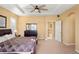 Bright bedroom with a ceiling fan, tray ceiling, and large windows at 11023 Glengate Cir, Highlands Ranch, CO 80130