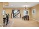 Open dining area with large sliding doors, elegant chandelier, and a bar at 11023 Glengate Cir, Highlands Ranch, CO 80130