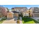 Attractive two-story home with a well-manicured lawn, a two-car garage, and a charming front entryway at 11023 Glengate Cir, Highlands Ranch, CO 80130