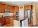 Functional kitchen with stainless steel refrigerator and breakfast bar at 11023 Glengate Cir, Highlands Ranch, CO 80130