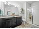 Modern bathroom features a double vanity, granite countertops, and a glass-enclosed shower at 4604 Copeland Cir # 101, Highlands Ranch, CO 80126