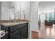 Bathroom featuring stone countertop vanity, and connecting door to other rooms at 4604 Copeland Cir # 101, Highlands Ranch, CO 80126