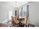 Bright dining area features modern chandelier, and a view to the home's exterior at 4604 Copeland Cir # 101, Highlands Ranch, CO 80126